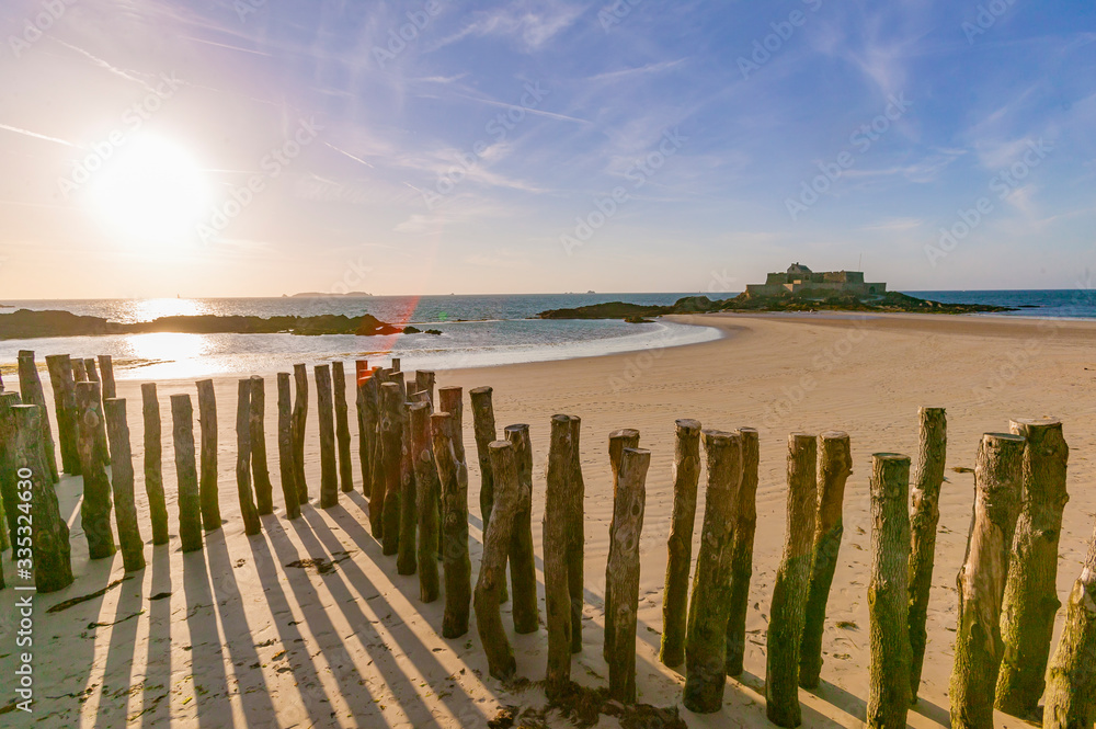 break wave, Ruins of Fortress and beach of Saint Malo at low tide, Brittany, France break wave, Ruins of Fortress and beach of Saint Malo at low tide, Brittany, France