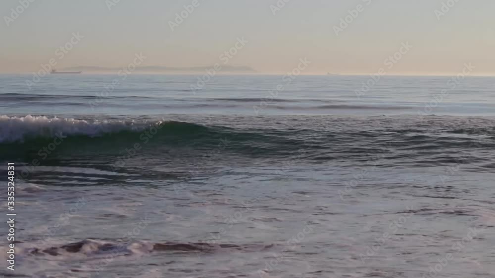 The silhouette of a transport ship goes along the coast of Africa, Morocco along the Gibraltarian Strait. The silhouette of a transport ship goes along the coast of Africa, Morocco along the Gibraltarian Strait.