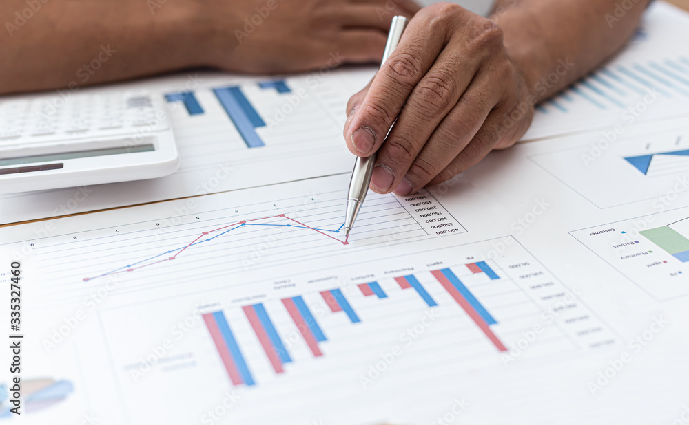Businessmen analyze market data and calculate the cost of buying-selling products for a client's company, Professional marketing and financial accountants concept. Businessmen analyze market data and calculate the cost of buying-selling products for a client's company, Professional marketing and financial accountants concept.