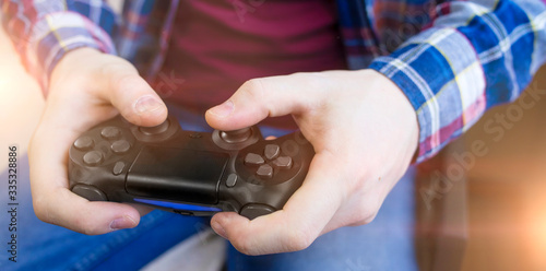 Man wearing checkered shirt playing video game