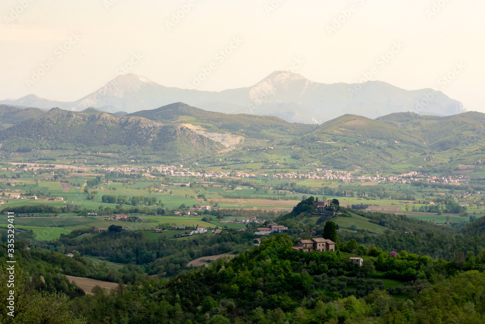 Amazing green landscape in central Italy, in Umbria between Gubbio and Assisi. Here the land is highly cultivated and there are a lot of beautiful old trees and many footpaths to walk in the nature