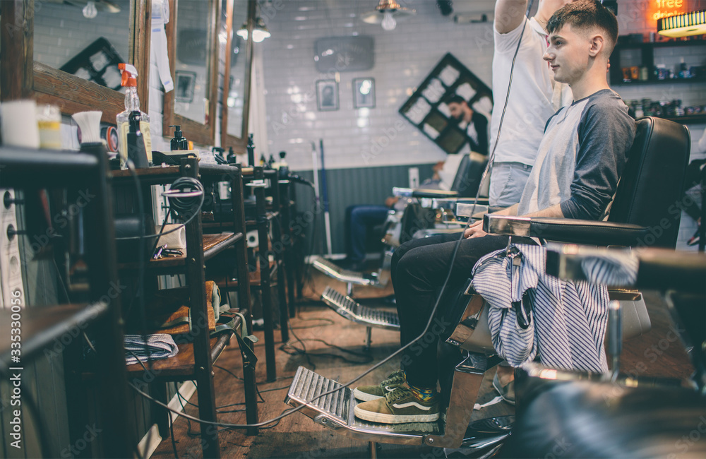 hairstylist and man client with haircut looking in mirror