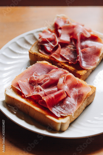 Toasts with serrano ham, traditional spanish breakfast