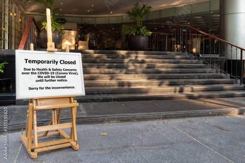 restaurant, hotel, company, shopping center closed due to coronavirus or covid-19 pandemic outbreak lockdown. coronavirus news temporarily closed board in front of building after government shutdown photo