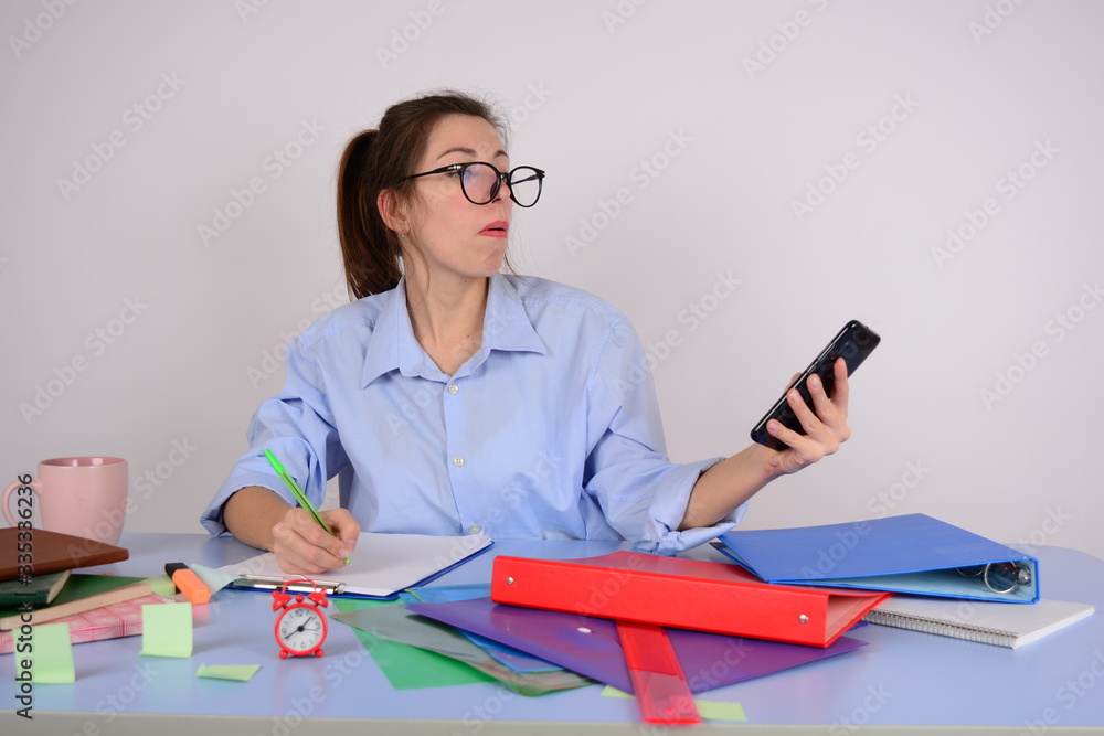 business woman in glasses looks at a smartphone business woman in glasses looks at a smartphone