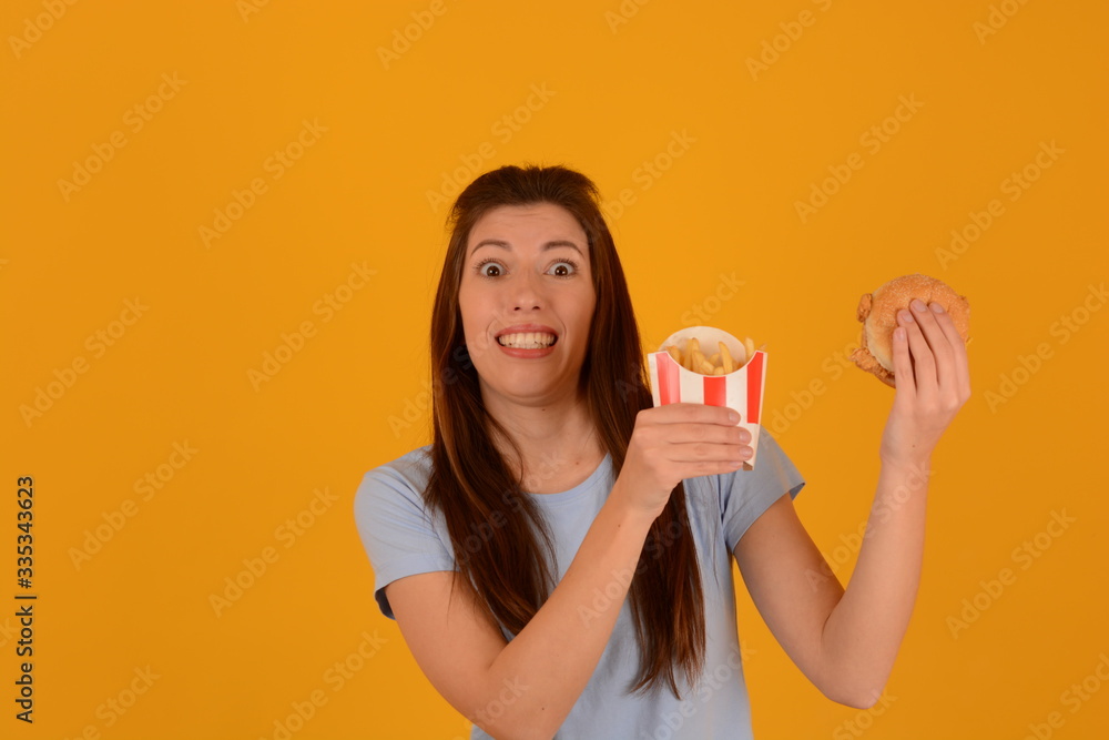 woman eating burger and french fries fast food advertisement junk food woman eating burger and french fries fast food advertisement junk food