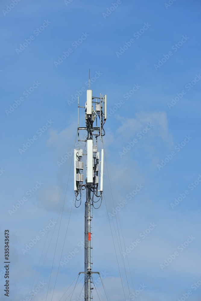 .Wireless Communication Antenna With bright sky.Telecommunication tower with antennas.High pole for signal transmission. There are both wireless phone systems and microwave systems. .Wireless Communication Antenna With bright sky.Telecommunication tower with antennas.High pole for signal transmission. There are both wireless phone systems and microwave systems.