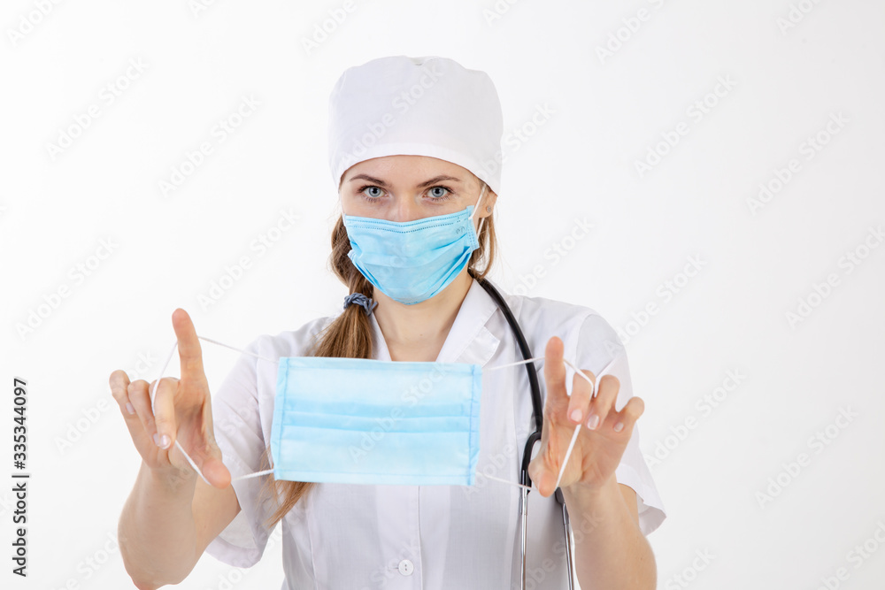 The doctor in a white coat puts on a mask. The doctor in a white coat puts on a mask.