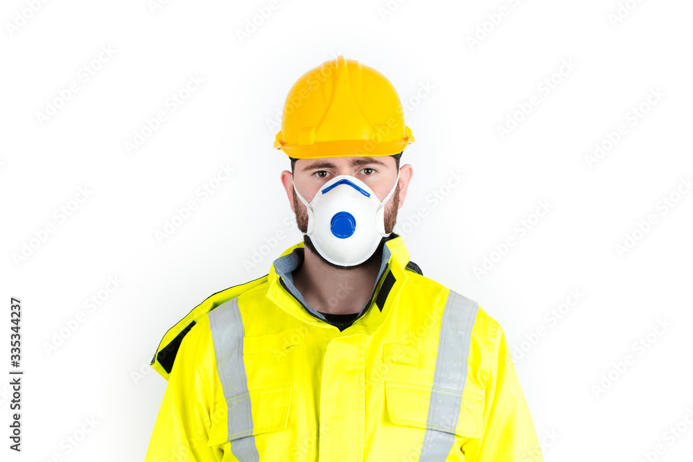 Young construction worker man wearing hard hat and medical mask. white background Young construction worker man wearing hard hat and medical mask. white background