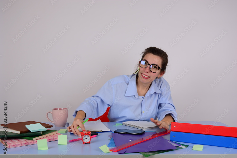 business woman in glasses sits at a table in the office business woman in glasses sits at a table in the office