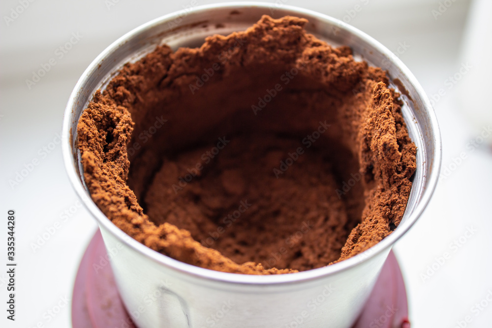 Ground coffee in a coffee grinder Ground coffee in a coffee grinder