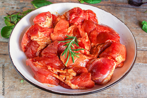 raw meat pork or beef in a plate on the table (preparing healthy food, marinade and spices paprika) menu concept background. top view. copy space for text