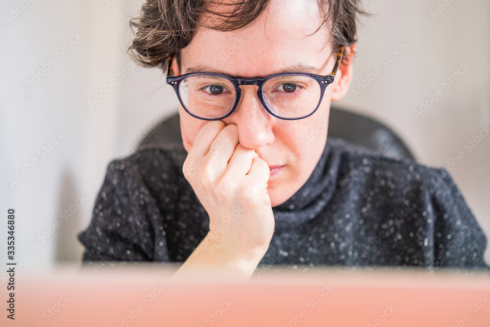 Woman working from home office. Young short hair entrepreneur woman concentrated, working online from home on computer laptop. Woman working from home office. Young short hair entrepreneur woman concentrated, working online from home on computer laptop.