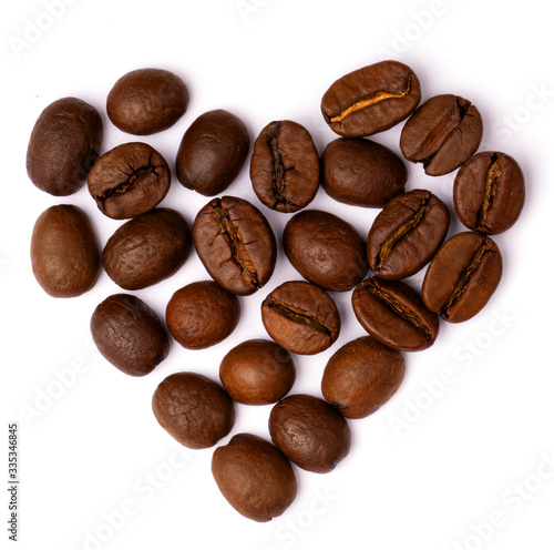 Heart shaped from premium coffee beans  isolated on white  close up 