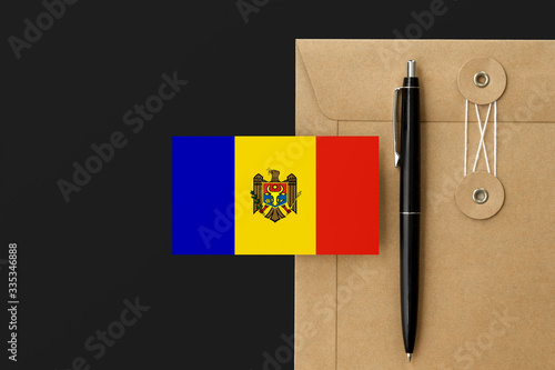 Moldova flag on craft envelope letter and black pen background. National invitation concept. Invitation for education theme.