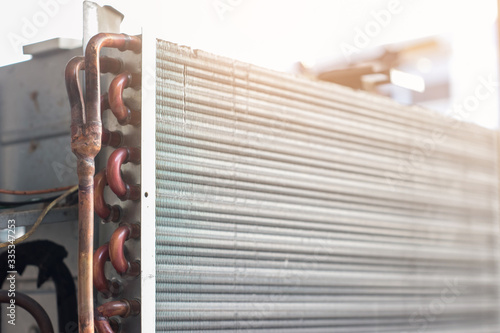 The air conditioner coil is a part of the system where the refrigerant absorbs heat. photo