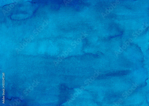 Watercolor deep sky blue background texture. Beautiful hand painted aquarelle backdrop. Stains on paper abstract painting. 