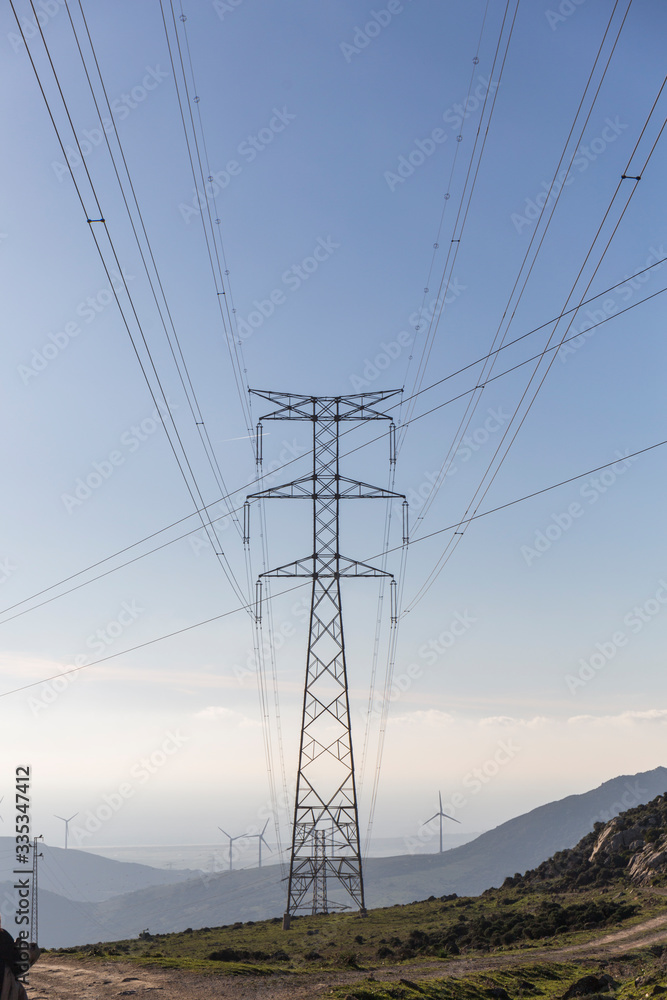 electricity antennas in the middle of the field, geometric shapes, cables that cut the blue sky electricity antennas in the middle of the field, geometric shapes, cables that cut the blue sky