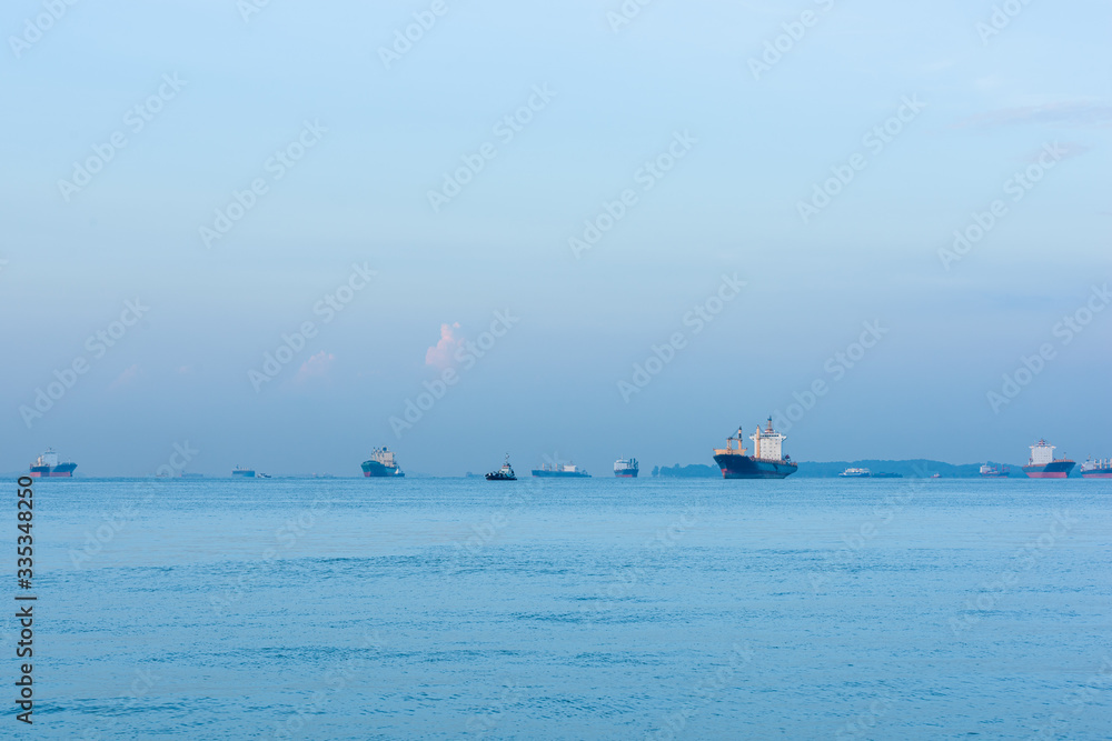 Cargo ships and oil tankers anchored offshore along the Singapore Straight, in Singapore Cargo ships and oil tankers anchored offshore along the Singapore Straight, in Singapore