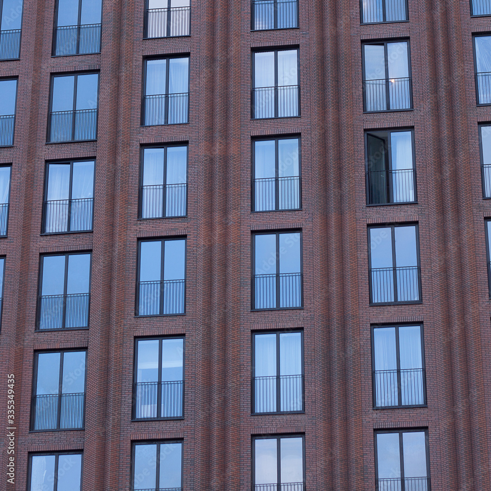 brick facade of a modern building with rhythmically placed windows brick facade of a modern building with rhythmically placed windows