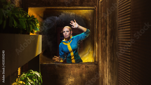 Survival woman looking at the window in apocalyptic shelter