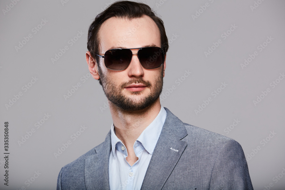 Studio portrait of handsome elegant young man in grey jacket Studio portrait of handsome elegant young man in grey jacket