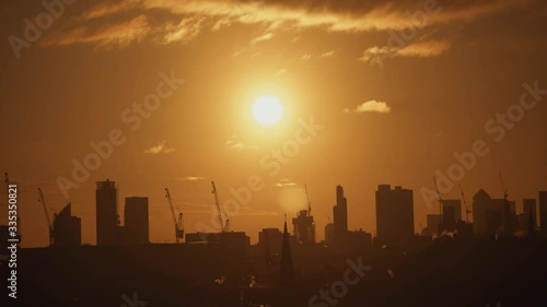 A silhouetted skyline of central London at an apocalyptic sunrise. photo
