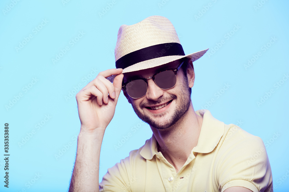 Closeup portrait of awesome hipster wearing fedora hat with intense look at  camera. Headshot over blue studio background. Stock Photo | Adobe Stock