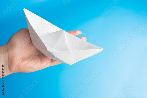 paper boat on blue background