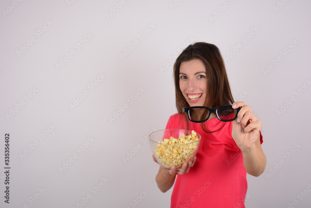 woman in pink t-shirt smiling holds glasses 3d plate popcorn movie woman in pink t-shirt smiling holds glasses 3d plate popcorn movie