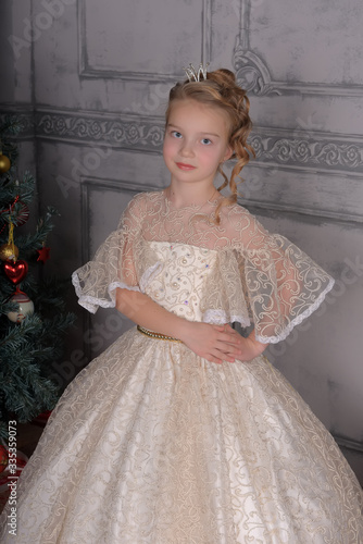 blonde princess in white elegant christmas dress