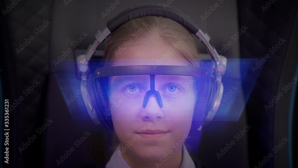 Girl with AR headset plunges into augmented virtual reality. Futuristic monitor on face with information hologram. Future concept. Girl with AR headset plunges into augmented virtual reality. Futuristic monitor on face with information hologram. Future concept.
