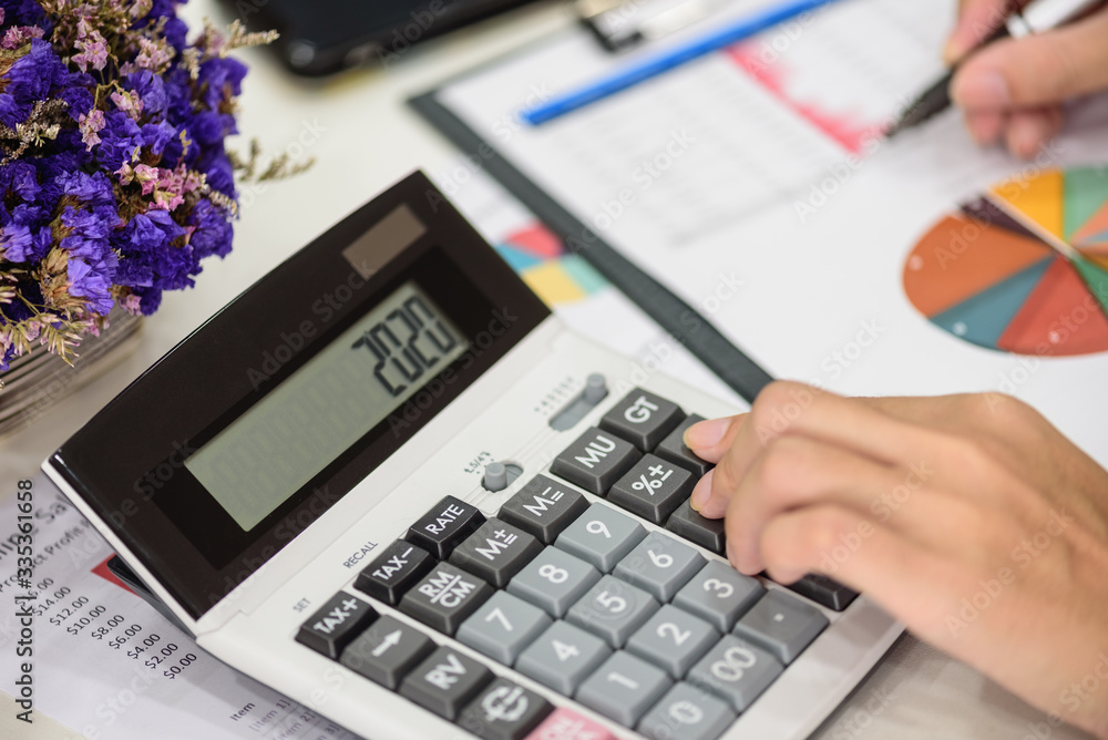 Closeup Accountants women are using calculators to analyze business financial data. Closeup Accountants women are using calculators to analyze business financial data.