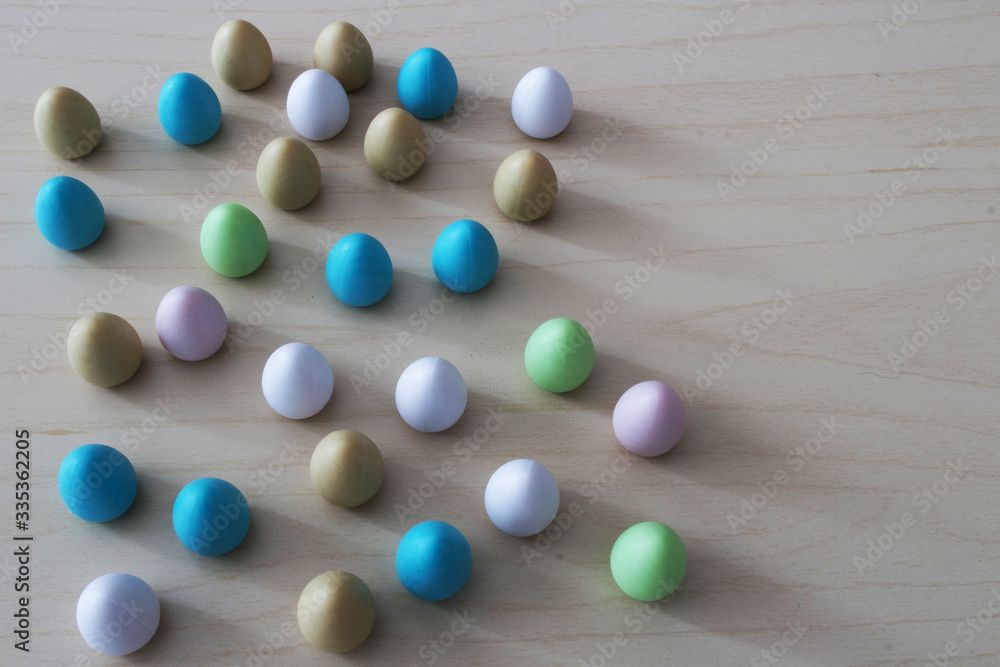 Colored wooden Easter eggs on table.