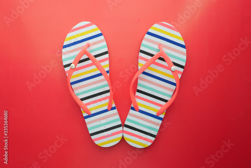 Female beige sandals on red background , top view.