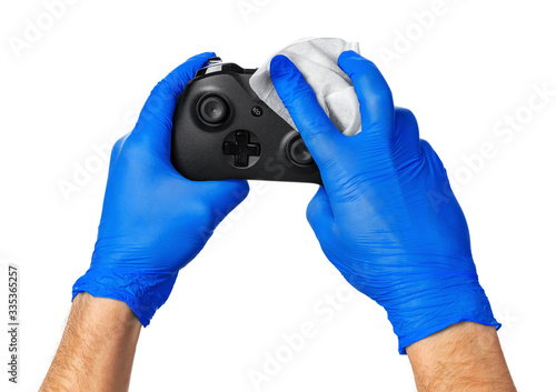 Video game console controller in gamer gloved hands. Games during isolation at home