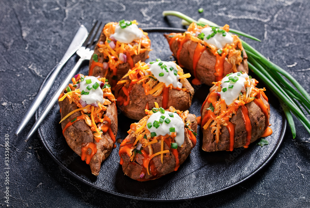 Loaded sweet potato skins on a dark background Loaded sweet potato skins on a dark background