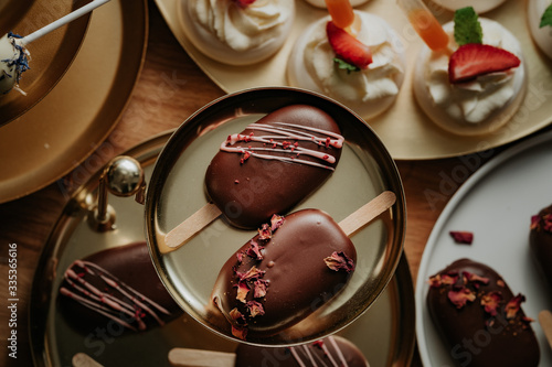 Sweet table at a wedding, monoportions and other sweets, cakesicles photo