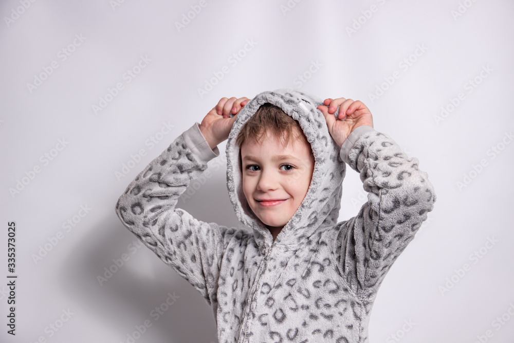 Boy in pajamas smiling on a white background Boy in pajamas smiling on a white background