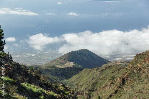 Aerial view of the west side of Tenerife Island. Hiking by the mountain trail surrounded by endemic vegetation and fields of lava rocks. Canary Islands, Spain