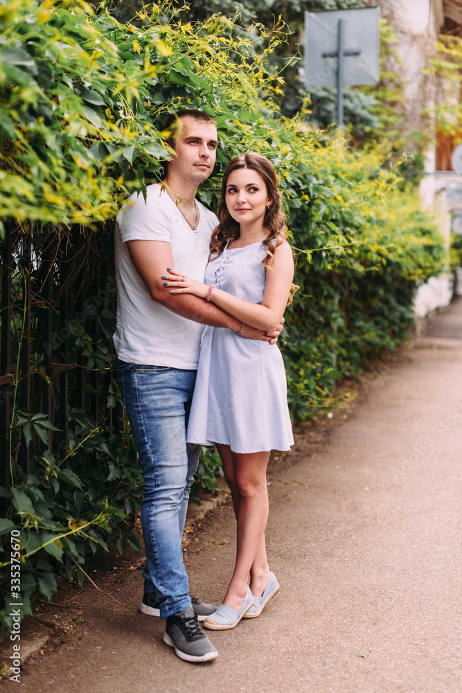 Loving couple on a city street. Portrait of a guy and a girl of love story. Life style Loving couple on a city street. Portrait of a guy and a girl of love story. Life style