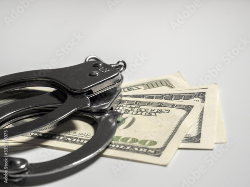 Punishment a violation of public order and insubordination of the police. fine and arrest. Handcuffs and dollars. during mass riots in America. copyspace photo