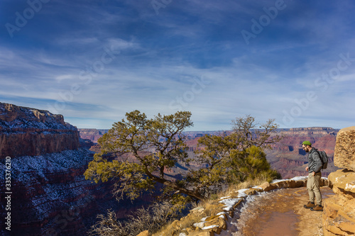 man tourist backpacker on a trail winter landscape of Grand Canyon National Park's South Rim