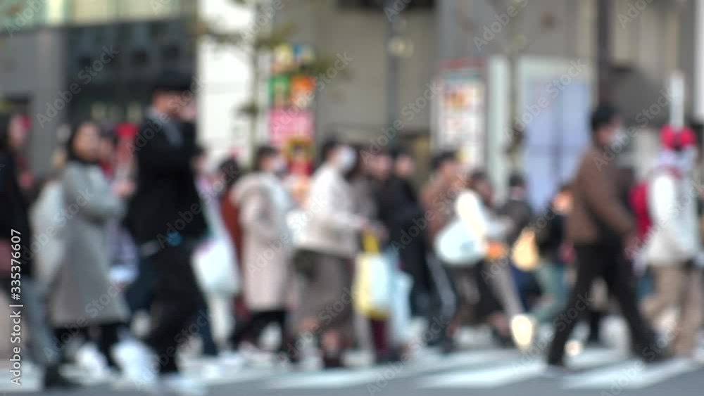 TOKYO, JAPAN -FEB 2020 : Crowd of people at Shibuya Scramble Crossing in busy weekend. Many pedestrians (Japanese people and tourist) at the street. Focus in front. Modern city lifestyle concept shot. TOKYO, JAPAN -FEB 2020 : Crowd of people at Shibuya Scramble Crossing in busy weekend. Many pedestrians (Japanese people and tourist) at the street. Focus in front. Modern city lifestyle concept shot.
