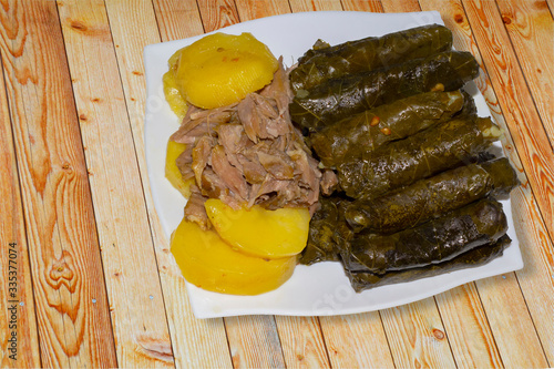 Grape vine leaves, stuffed with rice and meat ,a traditional Mediterranean countries dish, it's called in turkey (Sarma) and in Syria, Palestine,  Jordan, and Lebanon, is called Yabrak or Dwalli. photo