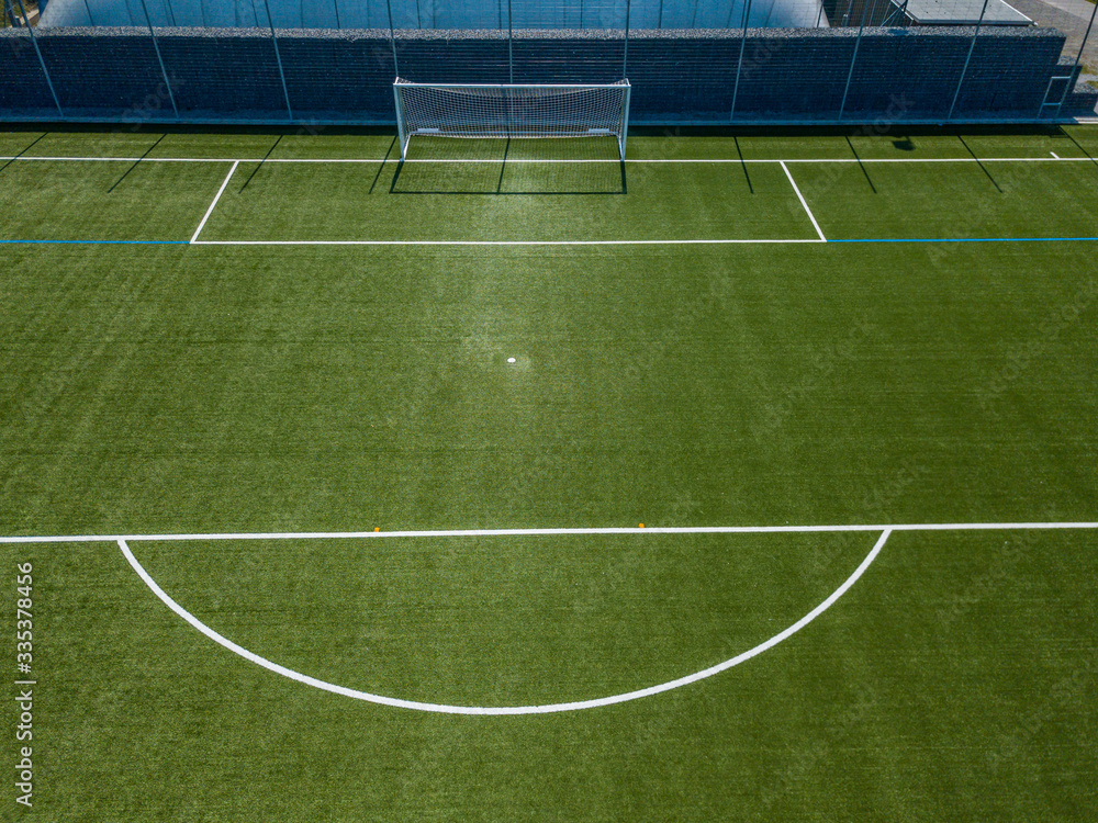 Aerial view of football goal and penalty area. Empty soccer field with white lines.