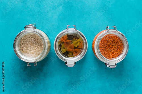 Glass boxes and bottles with quinoa, lentils, pasta organized home simple stylish storage