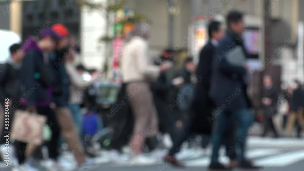 TOKYO, JAPAN -FEB 2020 : Crowd of people at Shibuya Scramble Crossing in busy weekend. Many pedestrians (Japanese people and tourist) at the street. Focus in front. Modern city lifestyle concept shot. TOKYO, JAPAN -FEB 2020 : Crowd of people at Shibuya Scramble Crossing in busy weekend. Many pedestrians (Japanese people and tourist) at the street. Focus in front. Modern city lifestyle concept shot.