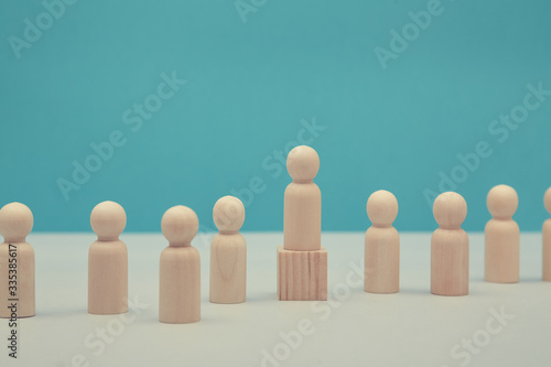 Sense of purpose, goal achievement mockup. Human resources. Career growth, HR.Wooden leader figure on cube. Copy space photo