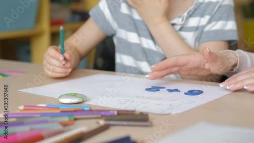 Home schooling. Mother and son doing art supplies homework